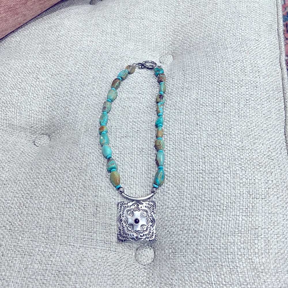18” turquoise necklace with a sterling silver pendant.